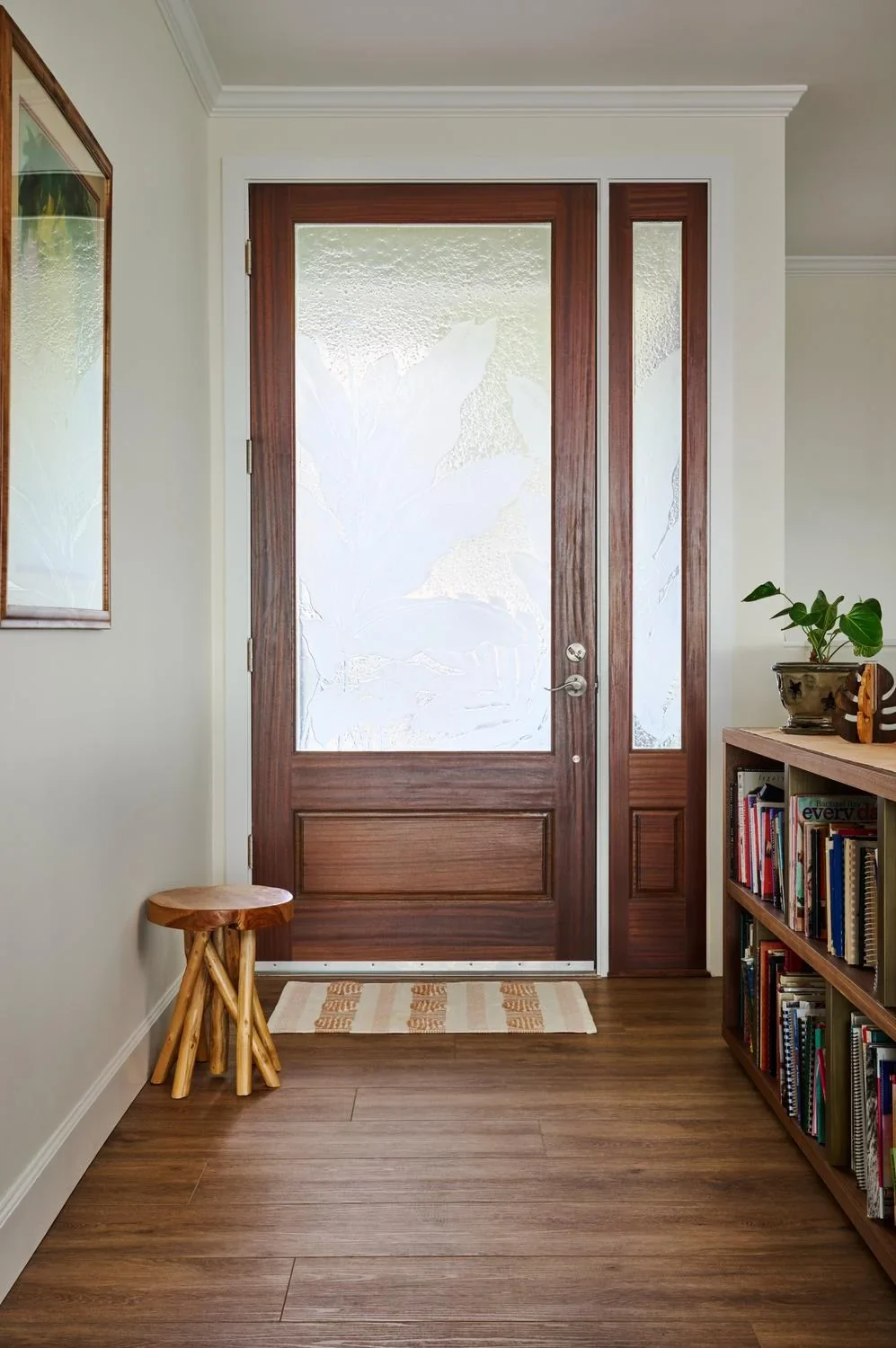 Home entry with a mahogany front door and wood-look plank flooring