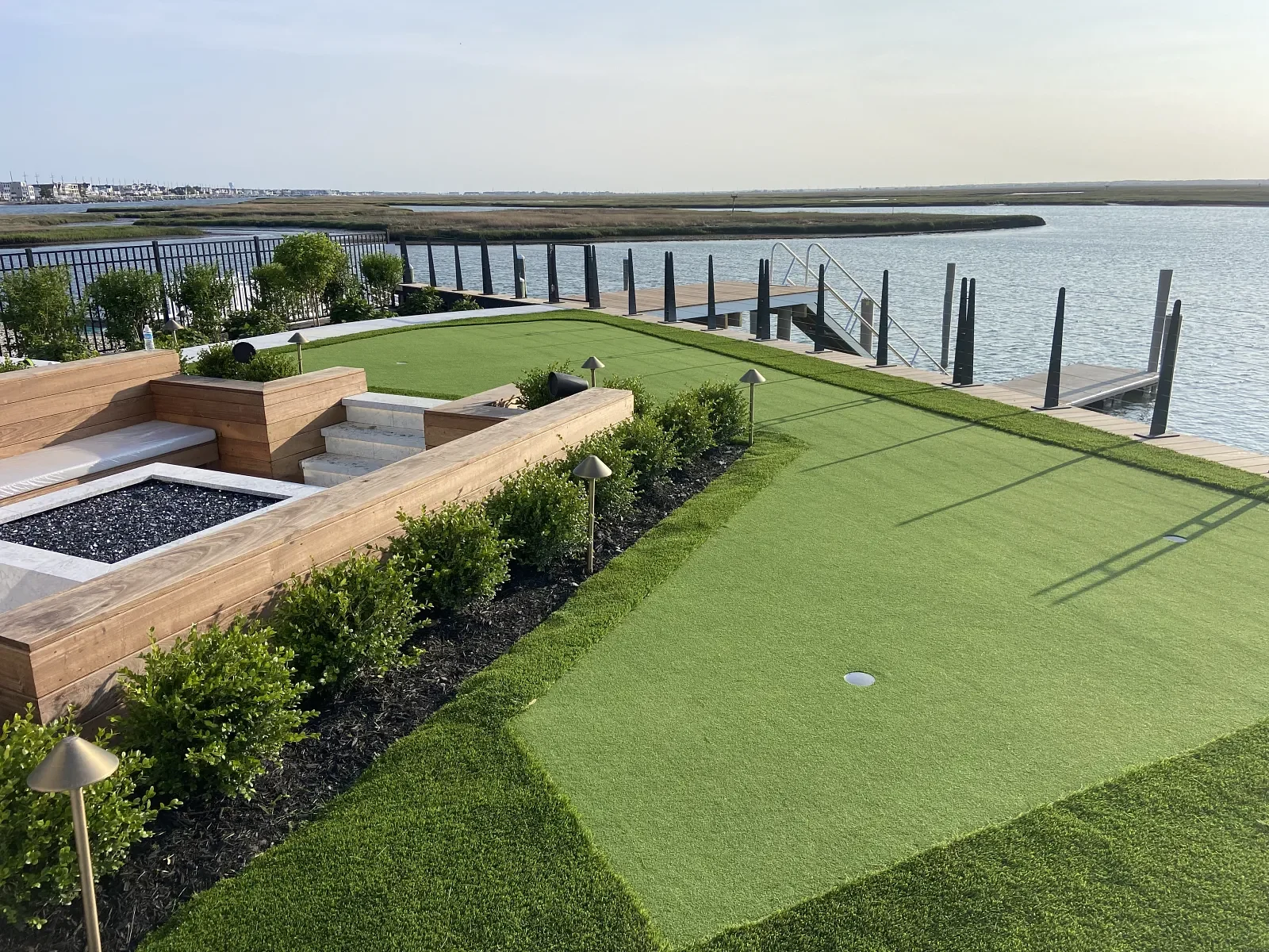 Backyard putting green with a waterfront view