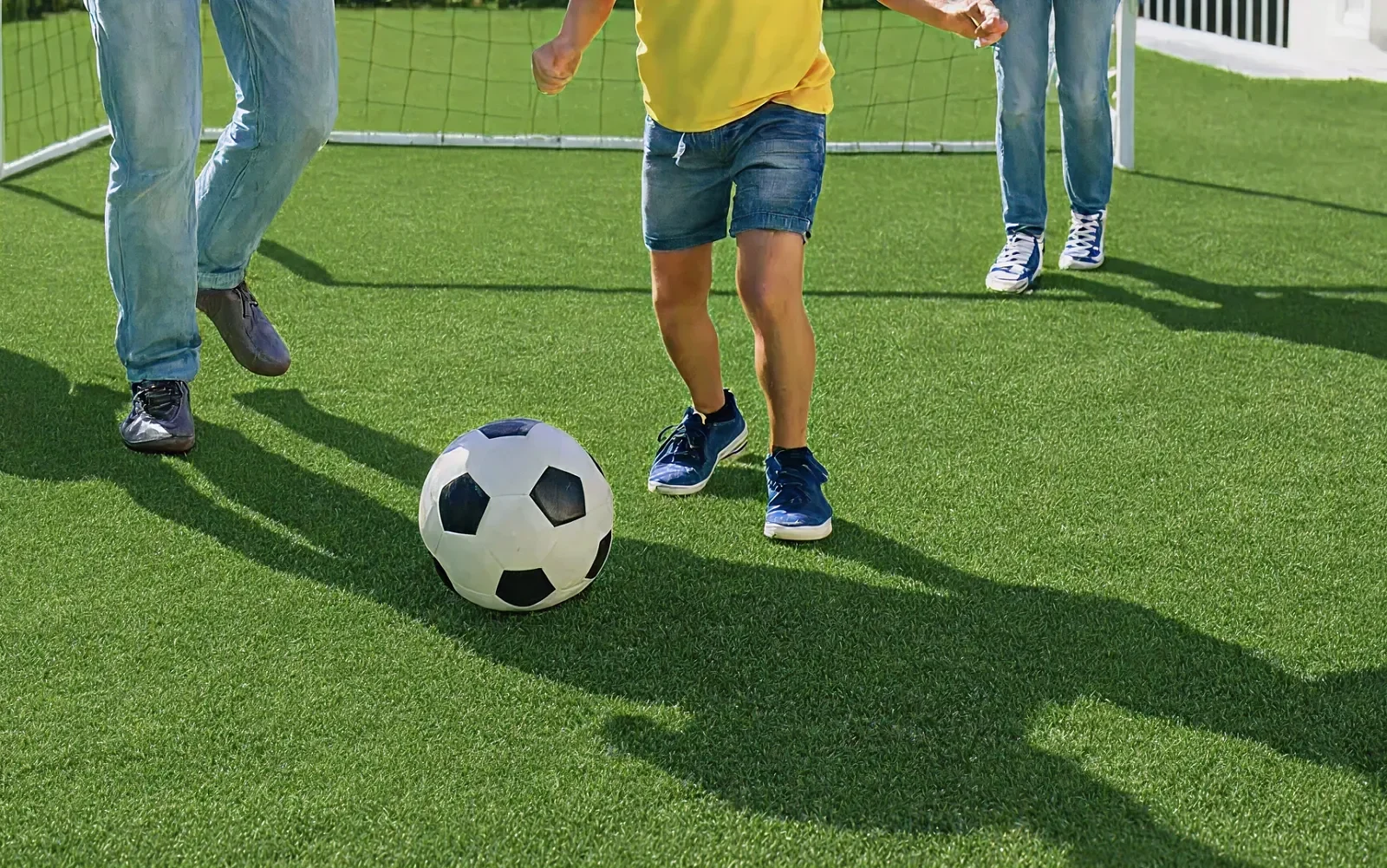 Children playing soccer on an artificial turf lawn