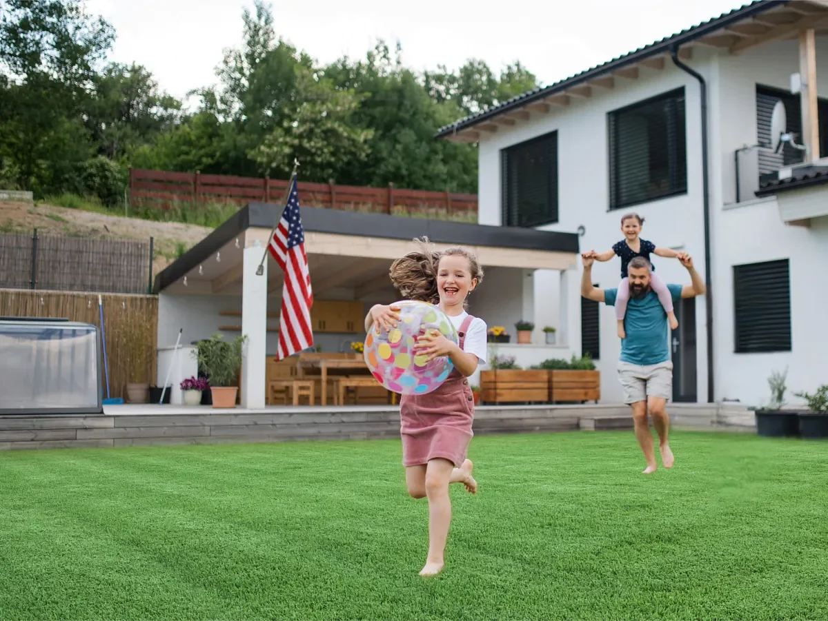 Family playing on a Foundations Heritage turf lawn